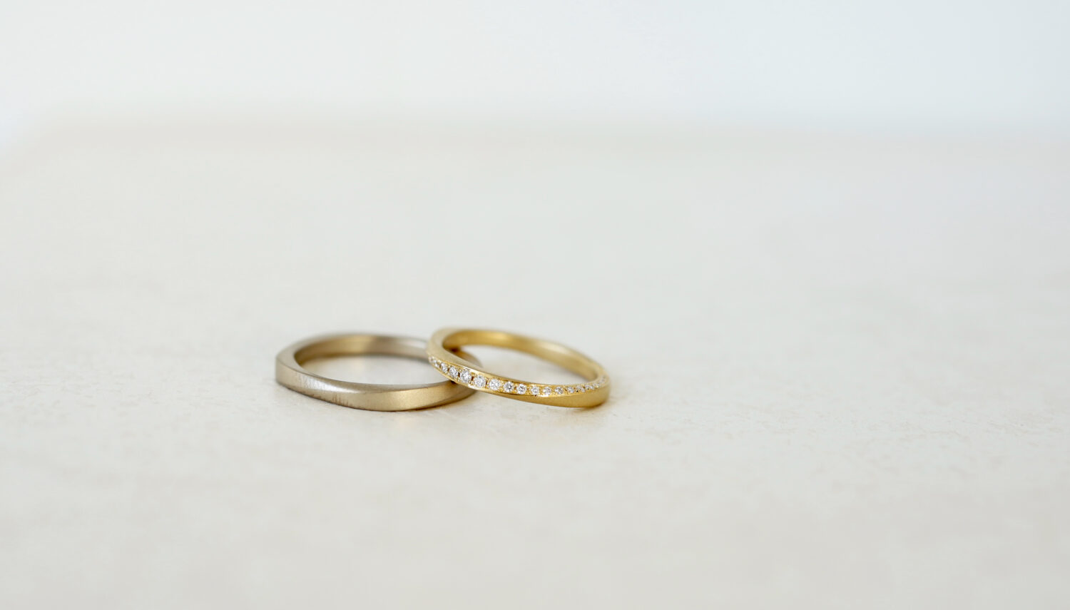 大阪心斎橋・京都のオーダーメード結婚指輪アトリエタマリのデザイン「ツイスト」ゴールドでの制作 マット仕上げ　女性のリングにはひねりに沿ってダイヤモンドを留めました