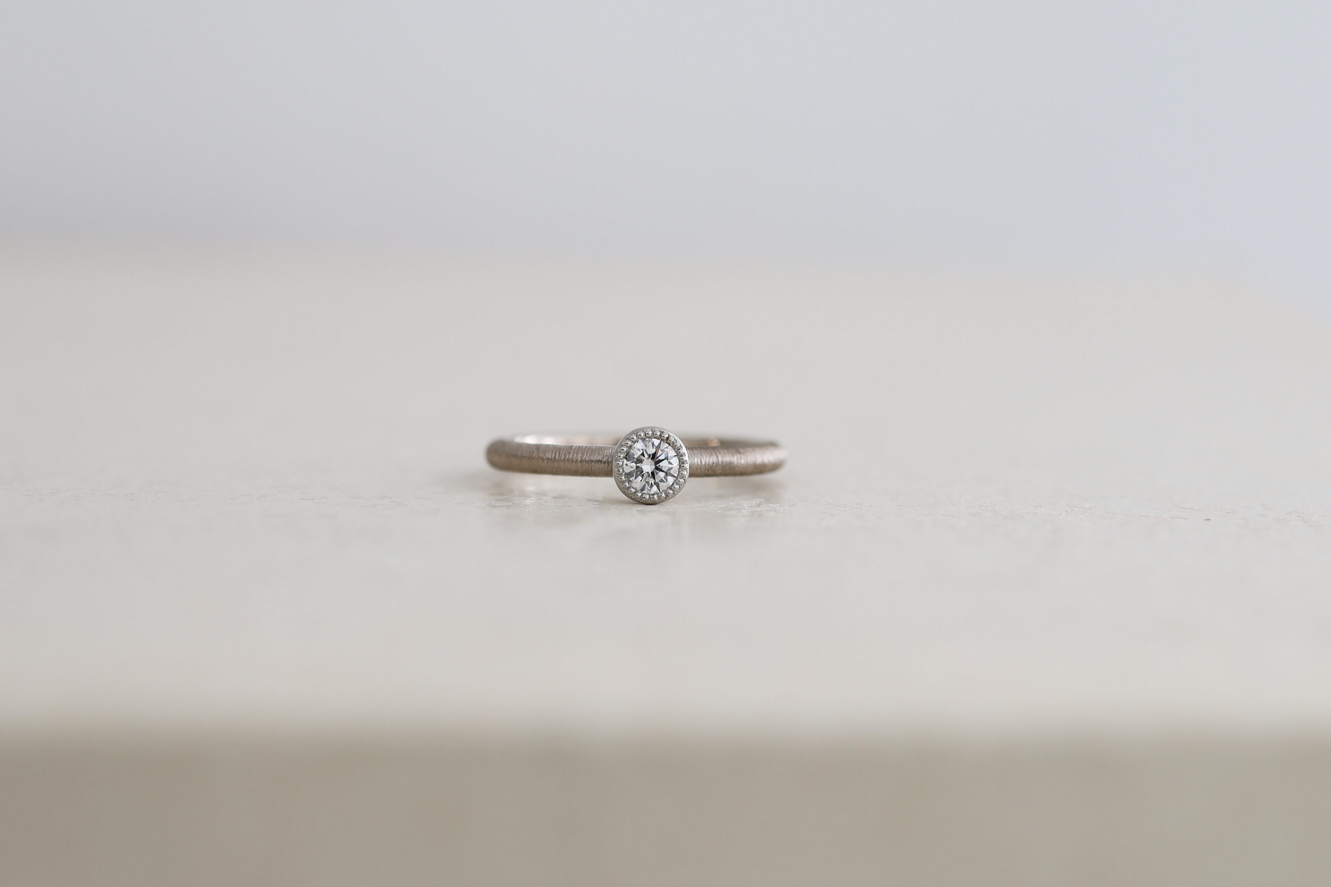 ふくりん枠のエンゲージリング。ミルグレイン。ホワイトゴールドとプラチナのコンビ