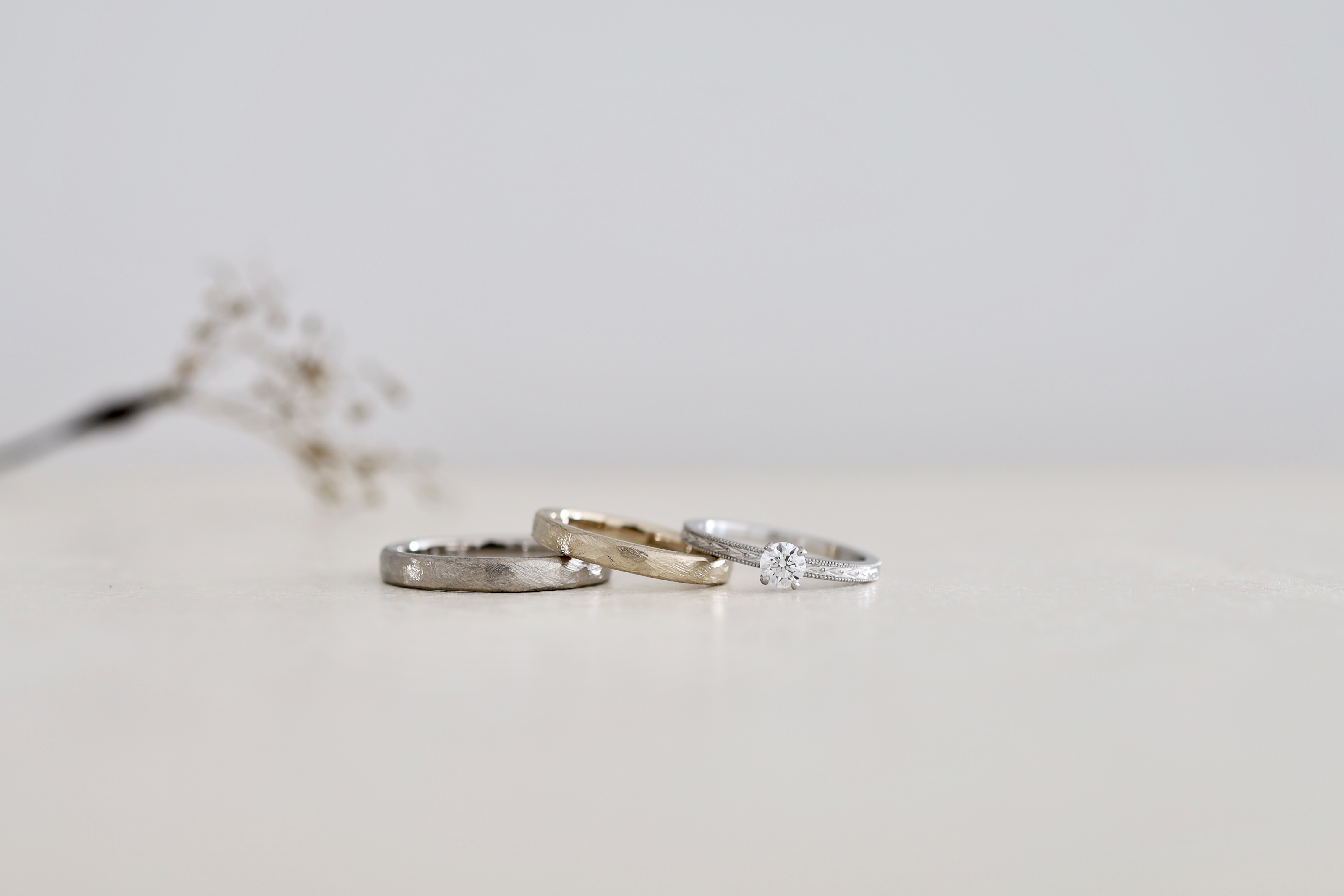 大阪と京都のウェディングリングアトリエ「アトリエタマリ」のマリッジ&エンゲージ。グレーゴールドとシャンパンゴールドのマリッジリングに、プラチナのエンゲージリング。アンティークな使い込んだ風合いが出てくる結婚指輪と、ミルグレインの婚約指輪の重ね付けを。